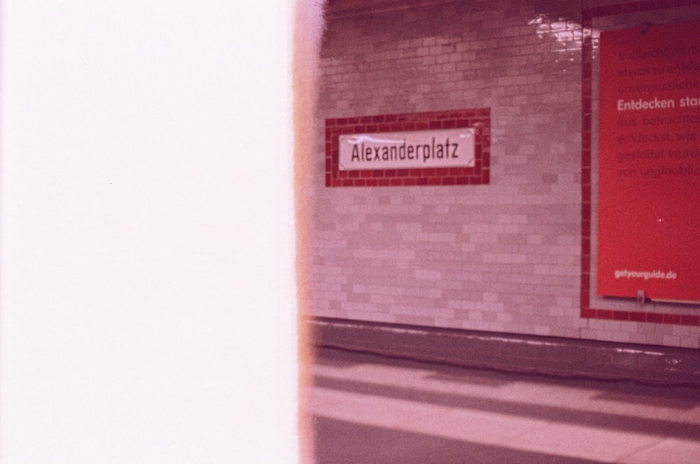 a subway station with a sign on the wall