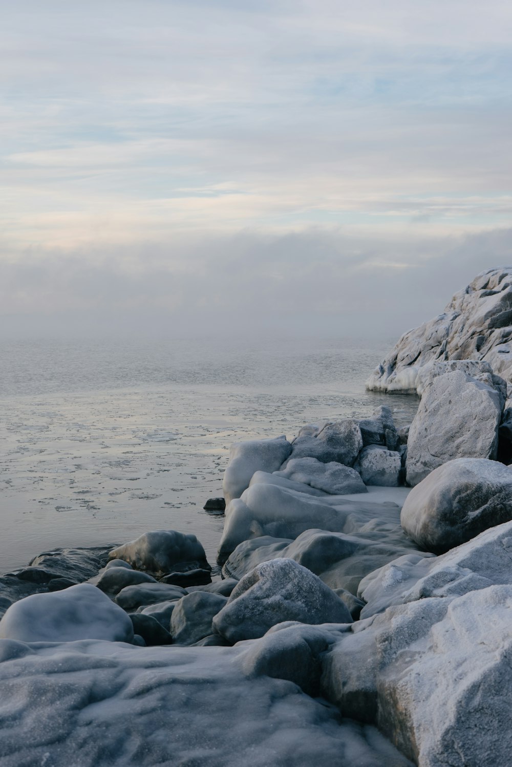 un rivage rocheux recouvert de neige et de glace