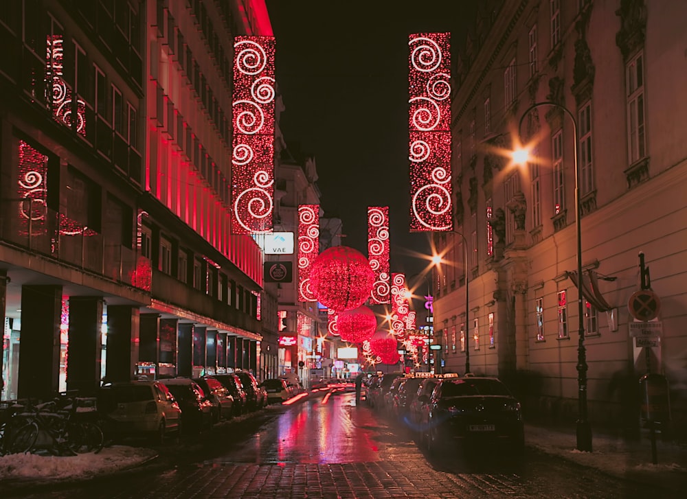 a city street is lit up with christmas lights