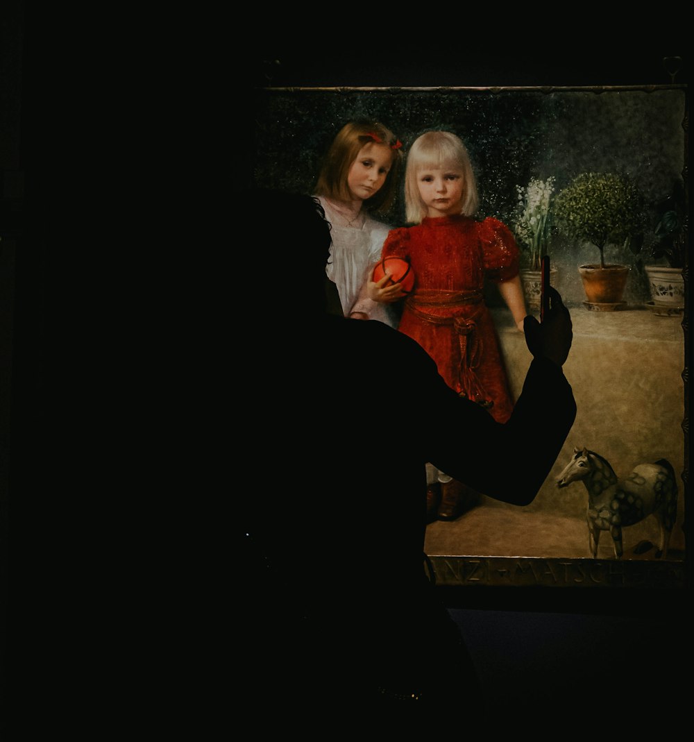 a painting of two young girls in a dark room