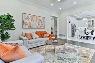a living room filled with furniture and a painting on the wall