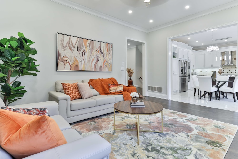 a living room filled with furniture and a painting on the wall