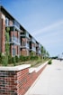 a red brick building with several balconies next to it