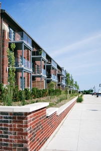 a red brick building with several balconies next to it