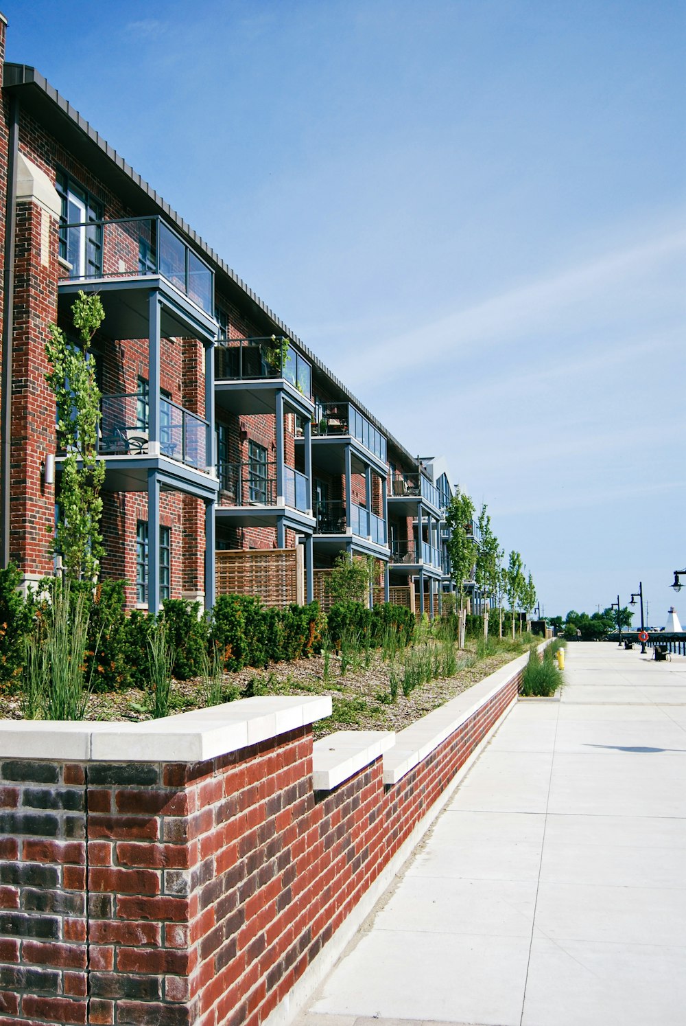 a red brick building with several balconies next to it