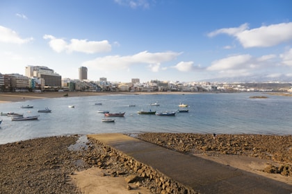 a group of boats floating on top of a body of water