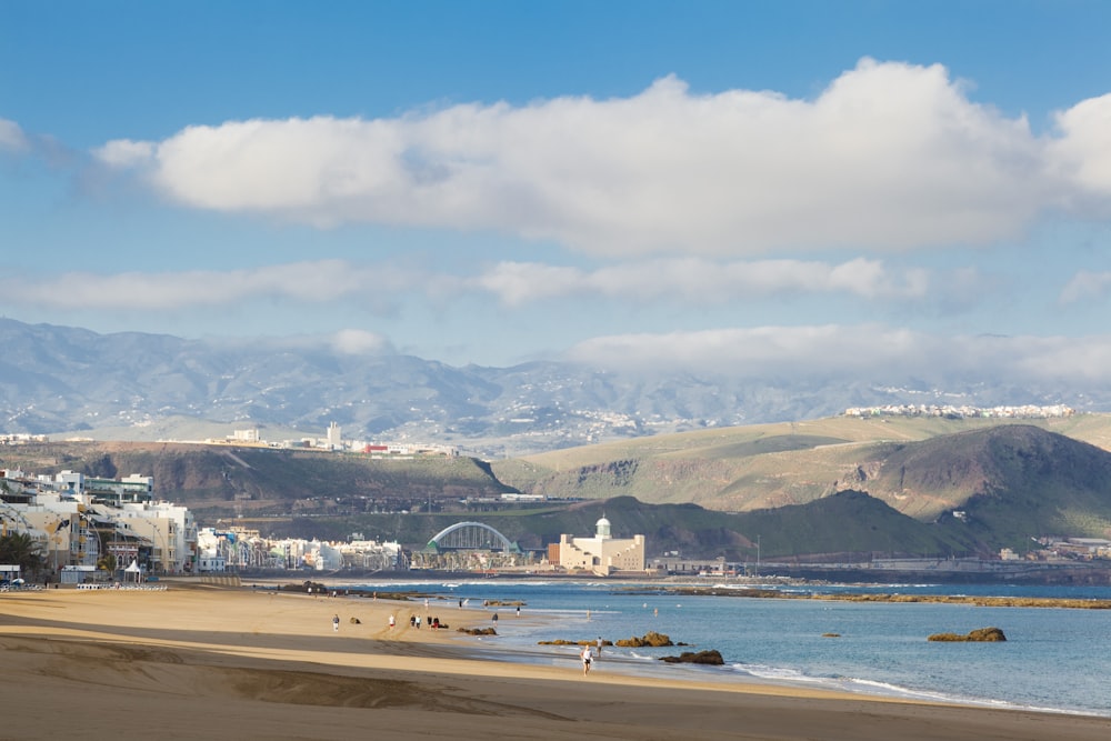 a view of a beach with mountains in the background