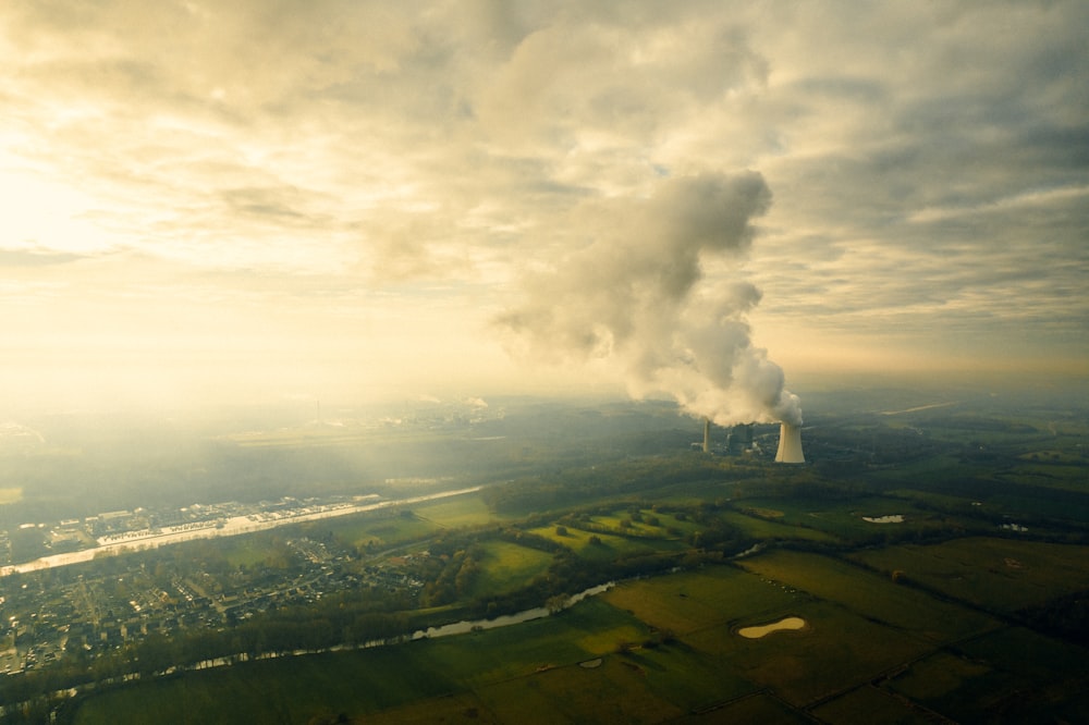 an aerial view of a power plant emitting smoke