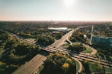 an aerial view of a highway with a stadium in the background