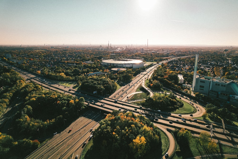 an aerial view of a highway with a stadium in the background