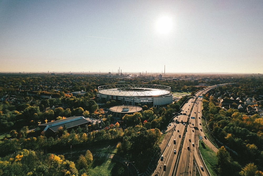 an aerial view of a large stadium surrounded by trees