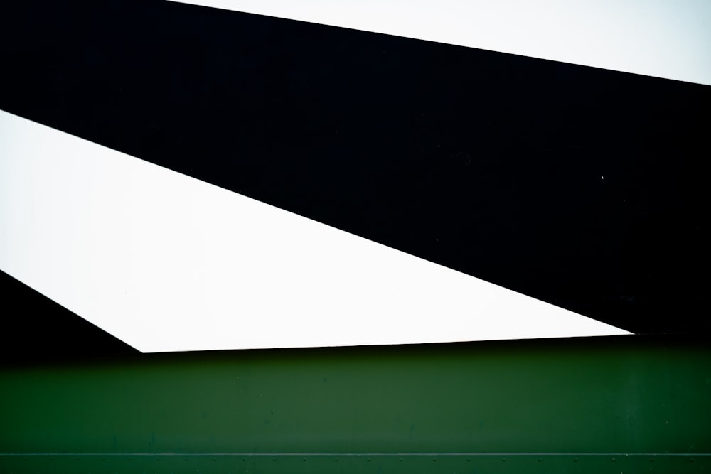 a black and white abstract painting with a green background