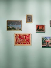 a wall with a bunch of paintings on it