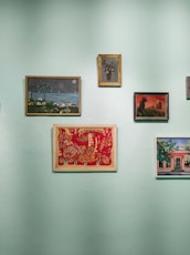 a wall with a bunch of paintings on it