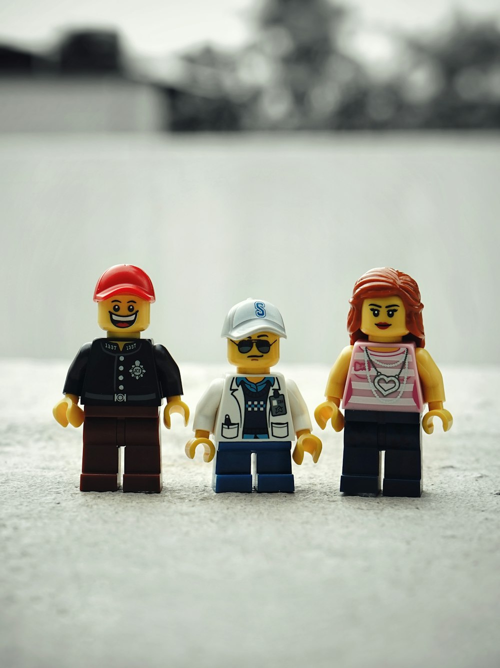 a group of three lego people standing next to each other