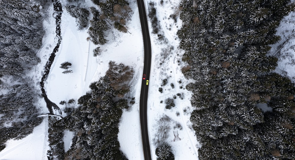 an aerial view of a road in the snow