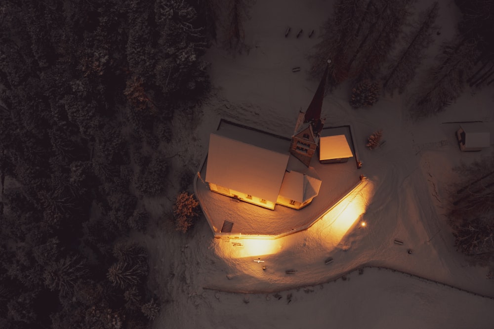 a church lit up at night in the snow