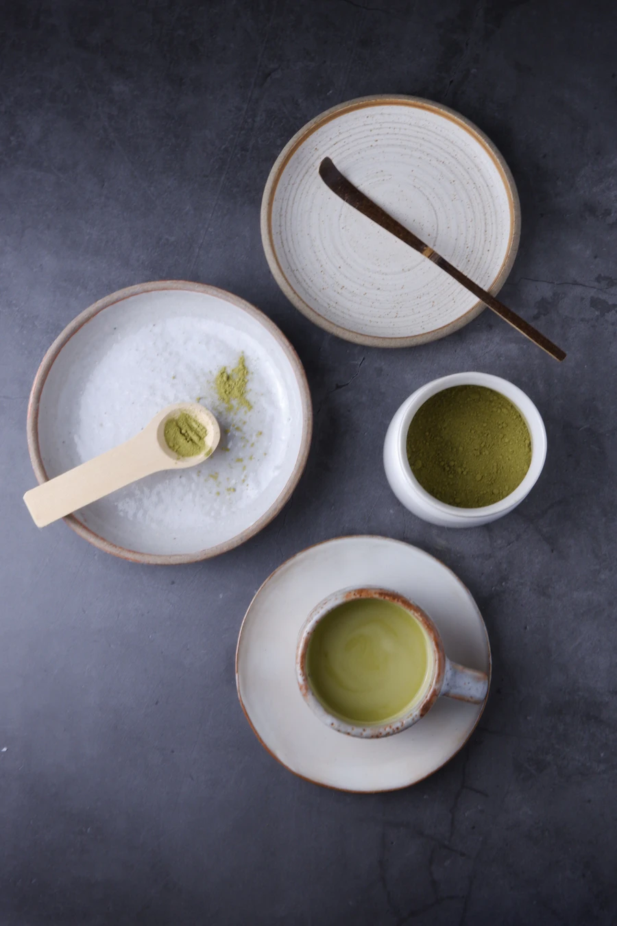 Matcha tea being prepared in a ceramic bowl