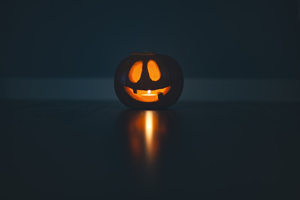 a lit up jack o lantern in the dark