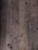 A close-up view of an old, worn-out wooden floor with numerous dark spots and blemishes. The planks show signs of aging and wear, including scratches, dents, and some areas where they appear to be splintering.