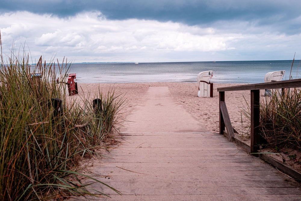 a sandy beach next to a body of water