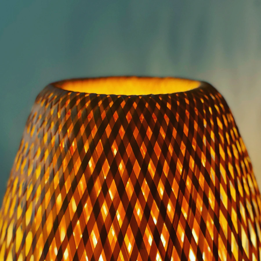 Woven decorative lamp illuminated with warm light