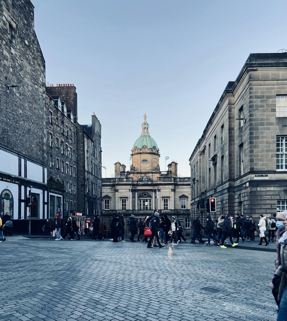 a group of people walking on a city street