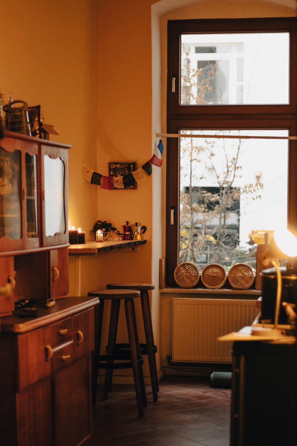 a kitchen with a window and a small bar stool