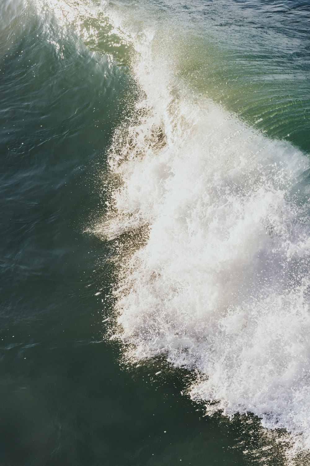 a man riding a wave on top of a surfboard