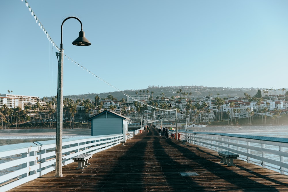 a pier with a light pole and a bench on it