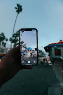 a person taking a picture of a street with a cell phone