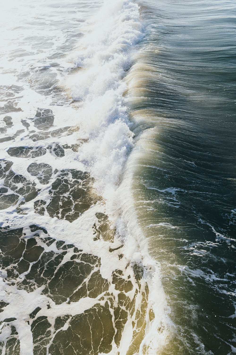 a person riding a surfboard on top of a wave