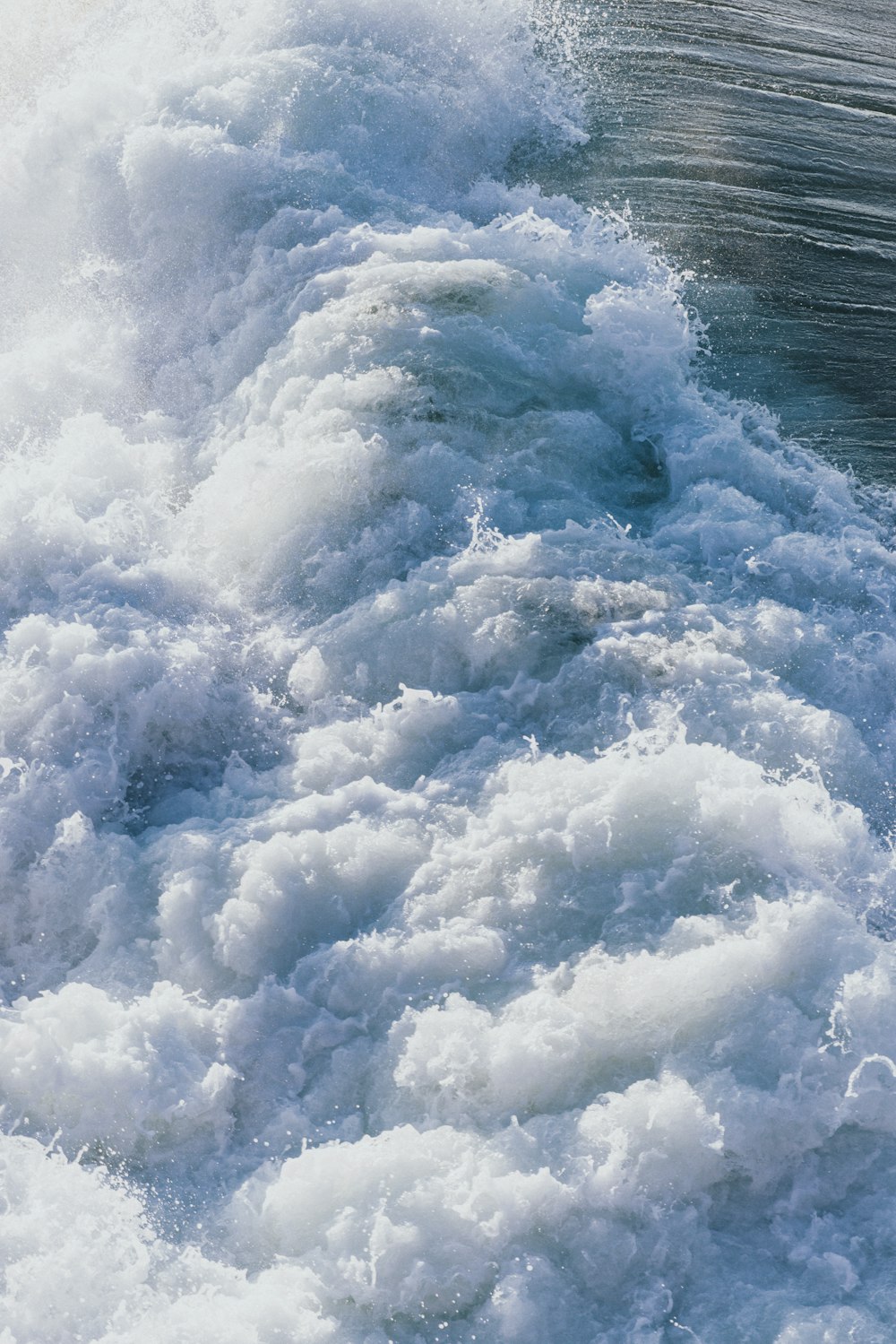 a man riding a surfboard on top of a wave