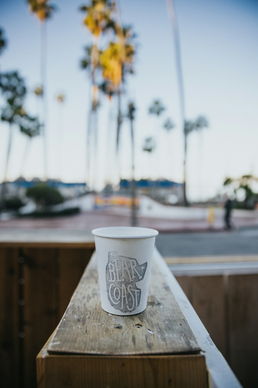 a cup of coffee sitting on top of a wooden table