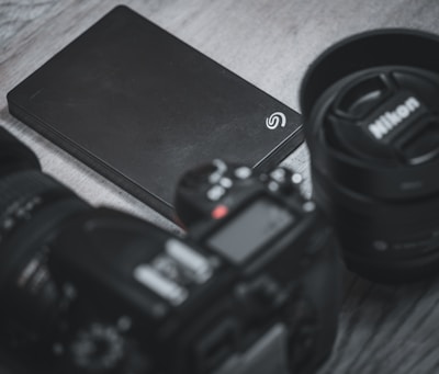 Storixa Quantum SATA drive resting on a wooden desk beside a cup of coffee and a notebook.