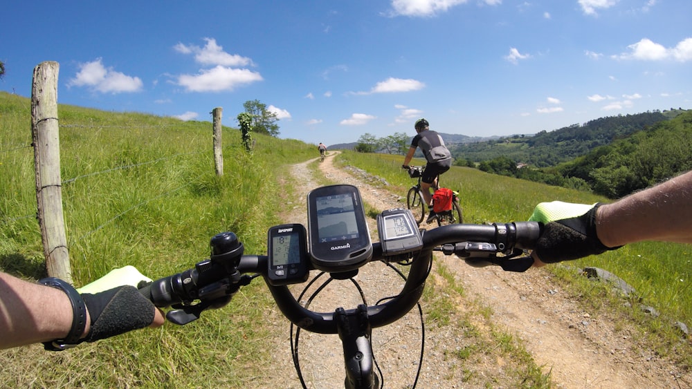 a man riding a bike down a dirt road