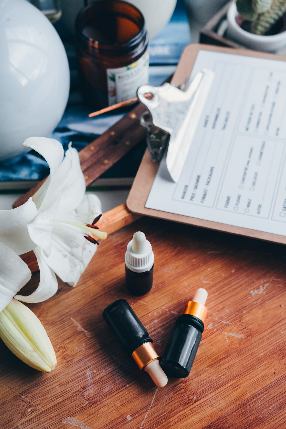 a wooden table topped with bottles of essential oils