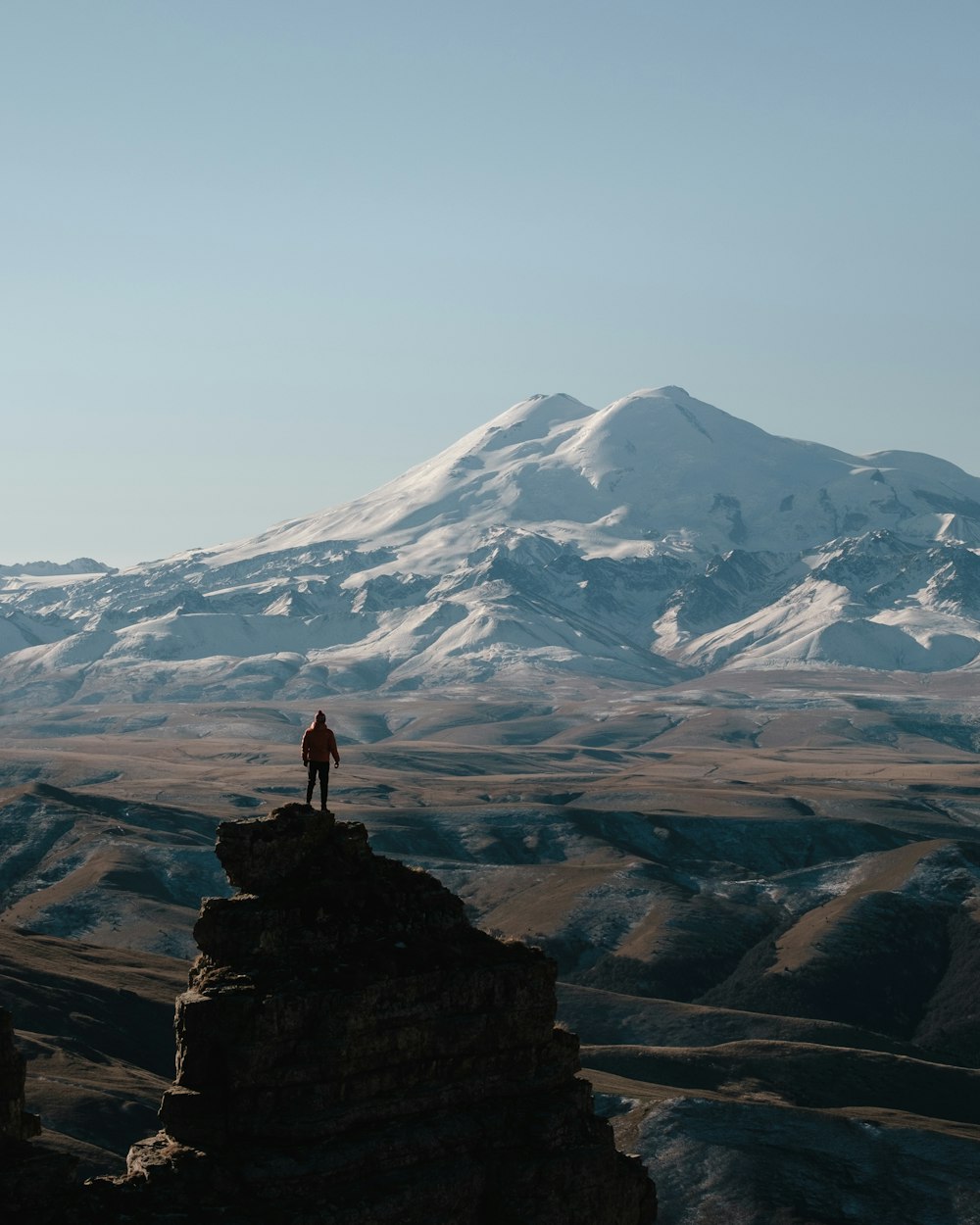 a person standing on top of a large mountain