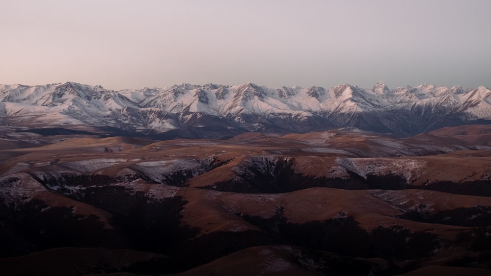 a view of a snowy mountain range from an airplane