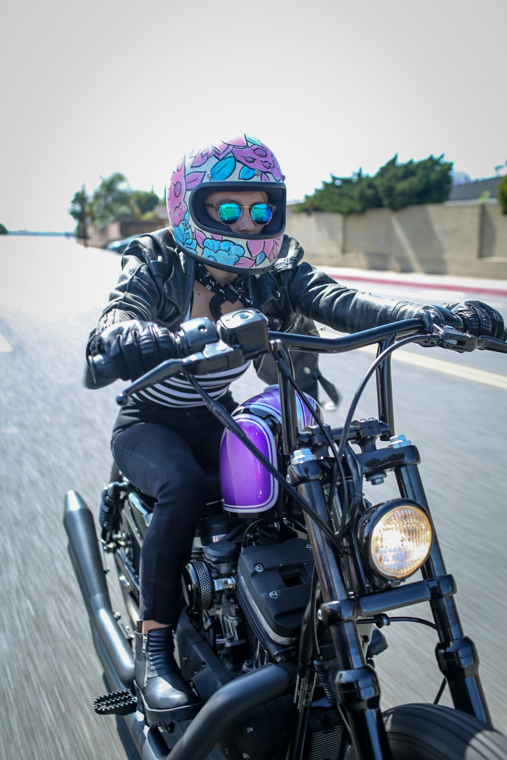 a person riding a motorcycle down a street