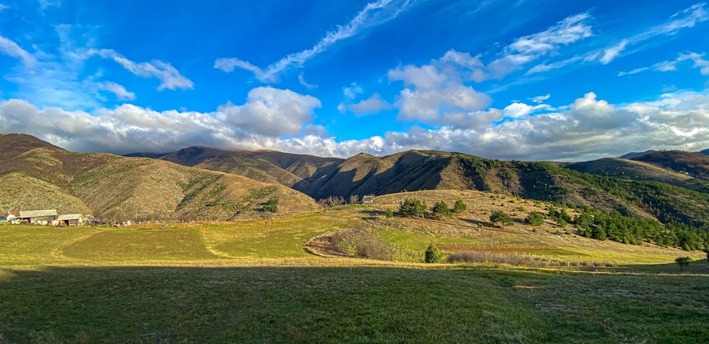 a scenic view of a mountain range under a blue sky