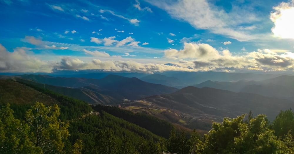 the sun shines brightly on the mountains