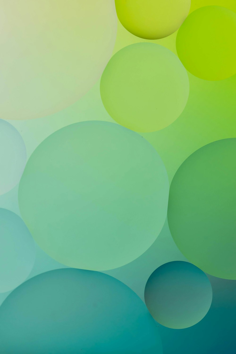 a green and blue abstract background with circles
