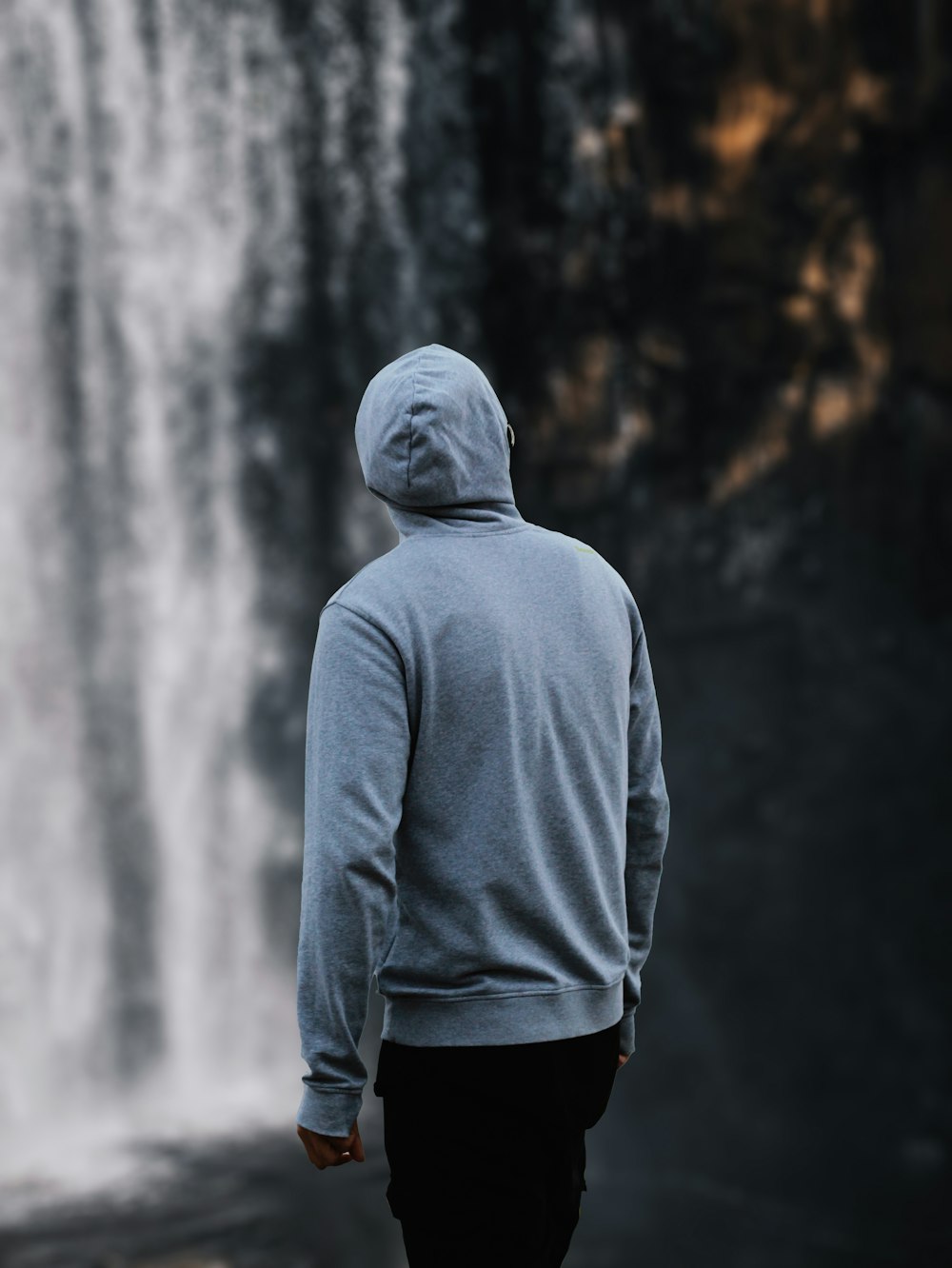 a person standing in front of a waterfall