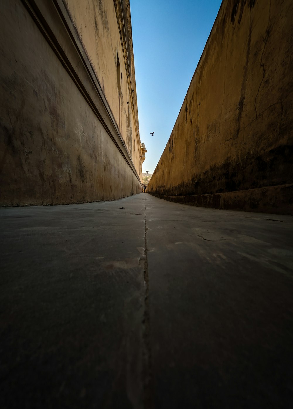 a long narrow street with a sky background
