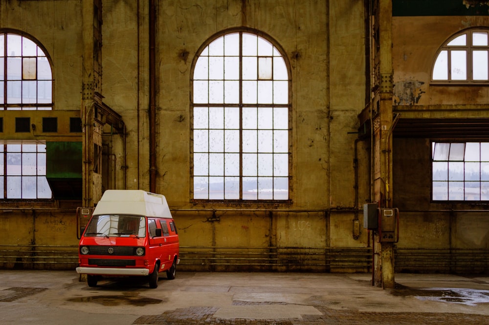 a small van parked in a large building