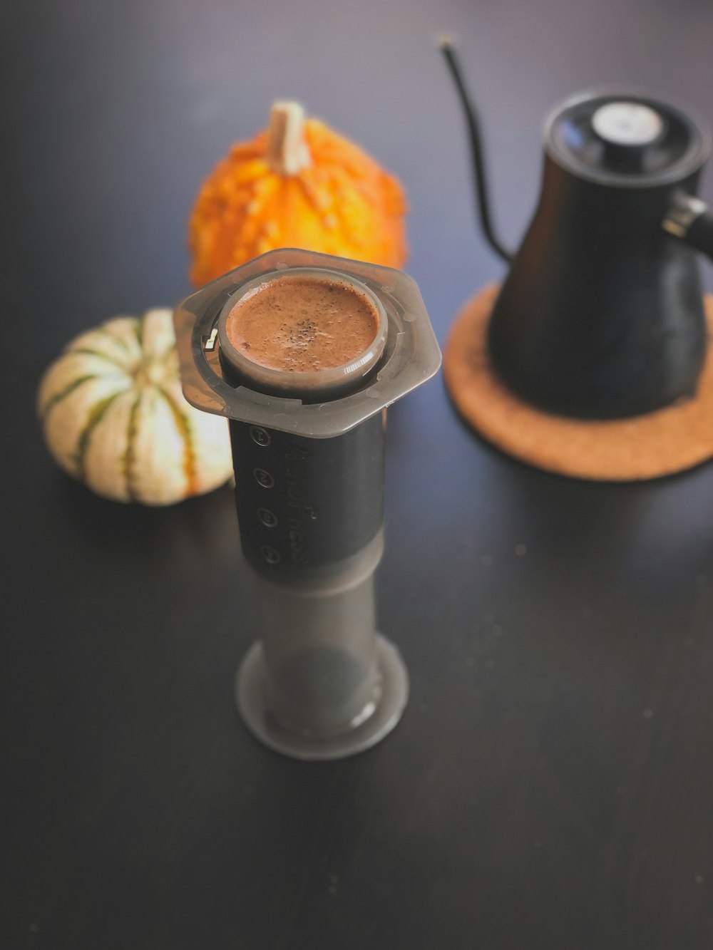 a cup of coffee sitting on top of a black table