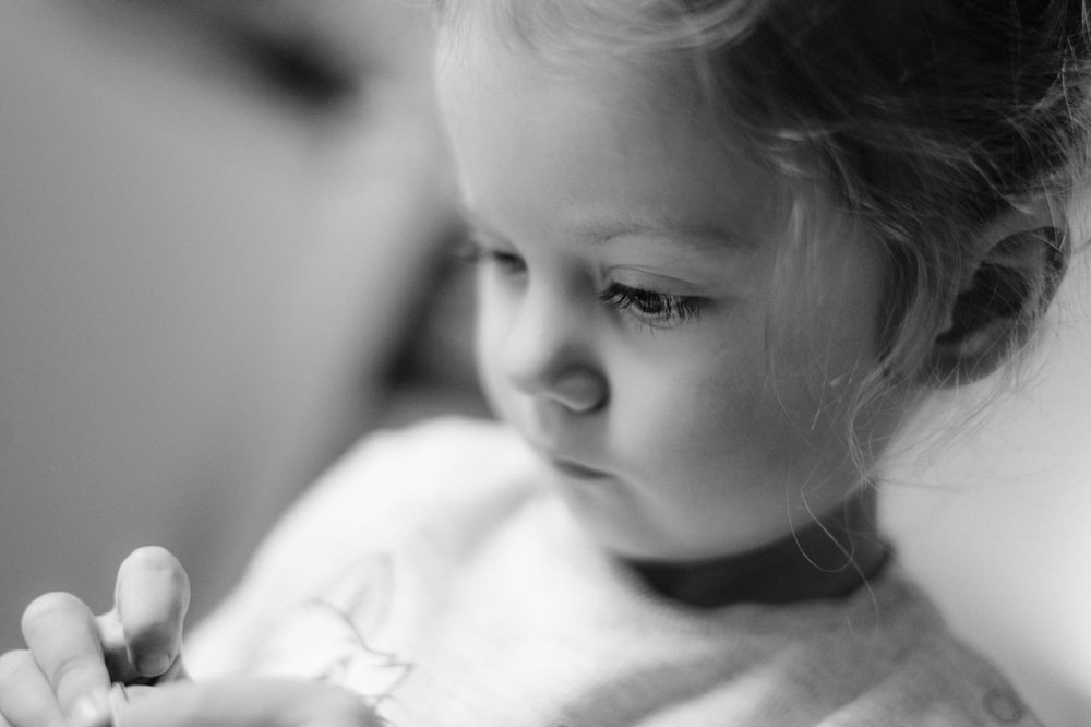 a little girl that is holding a cell phone