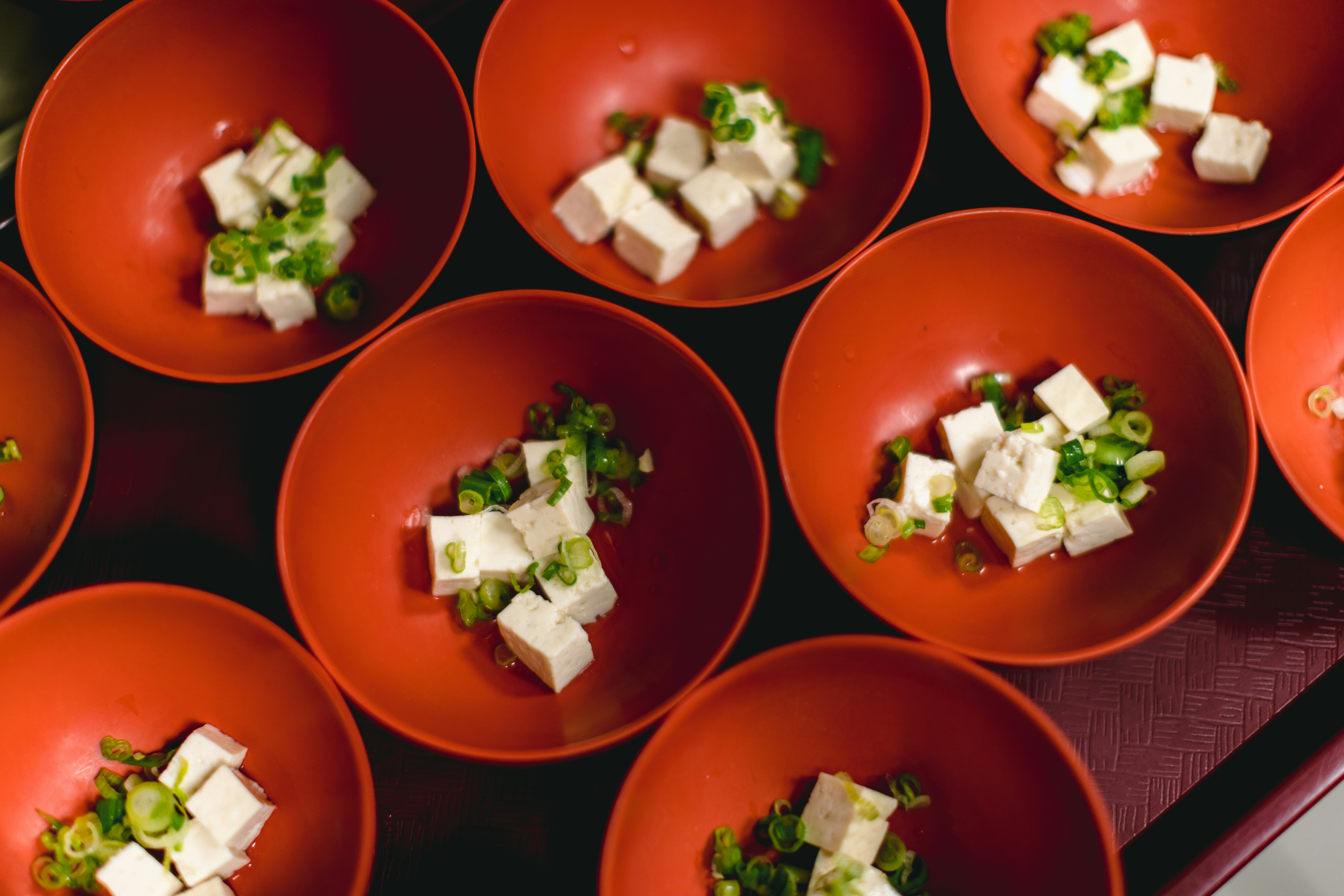 Red bowls of tofu