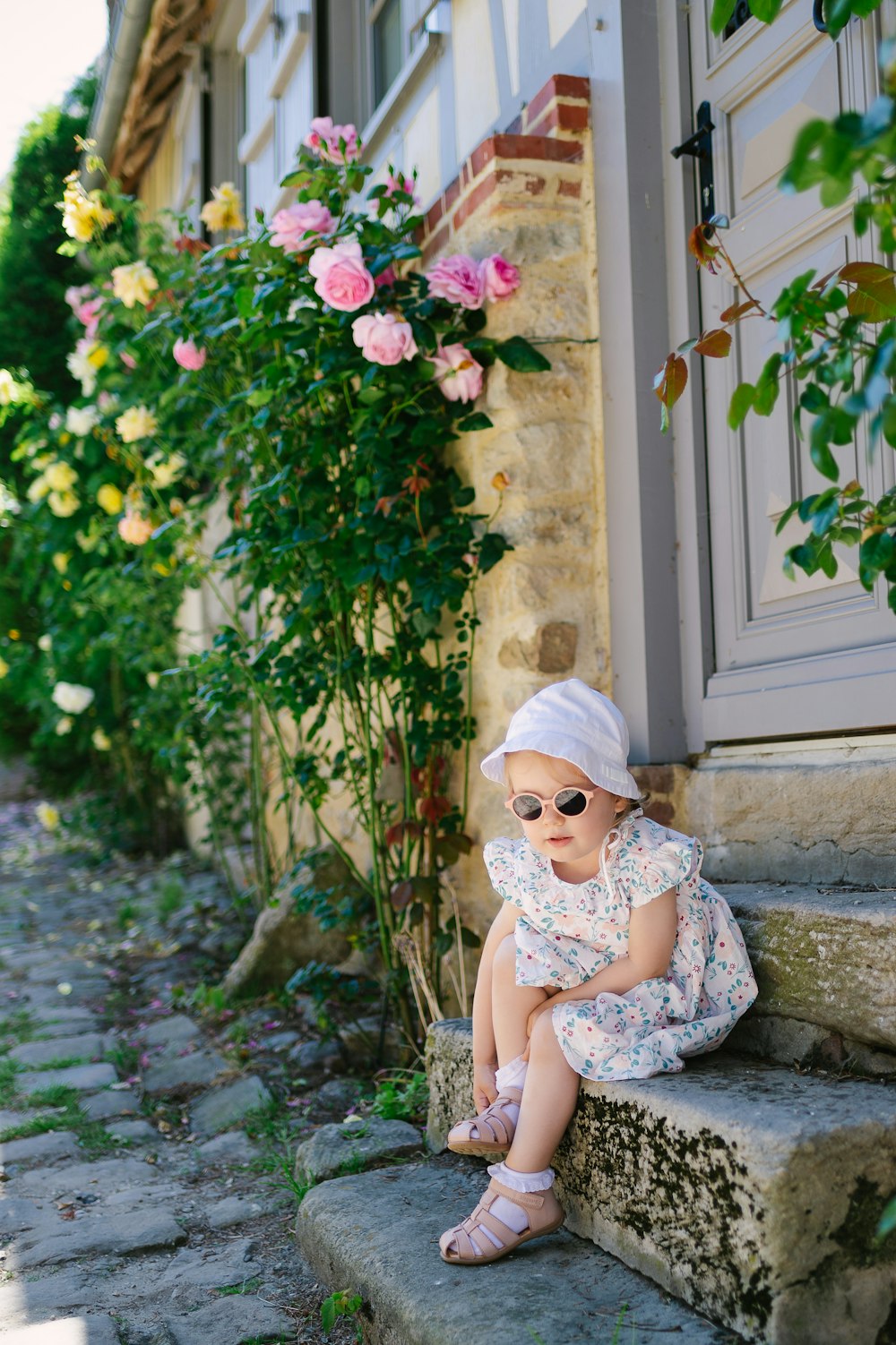 a little girl that is sitting on some steps